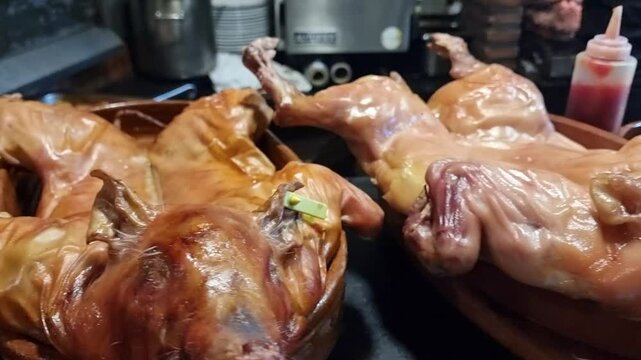Delicious wood-fired roasted suckling pigs with crispy golden skin, freshly cooked and ready to serve. A traditional gourmet feast showcasing authentic rustic culinary mastery.