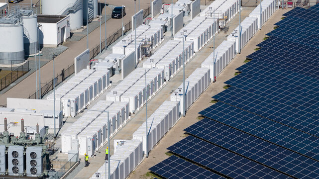 Aerial view of the ENGIE Maxima plant battery energy storage system and solar panels under bright sunlight in Lelystad, Flevoland, Netherlands.