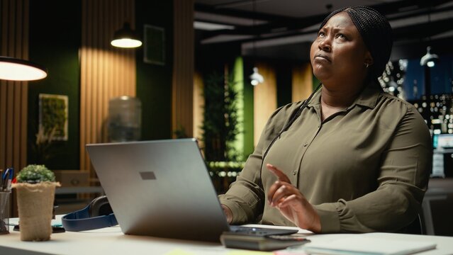 General manager engages in methodical planning after hours at corporate office, envisioning ideas and reflecting on business outlooks to turn challenging problem into tactical solution. Camera A.