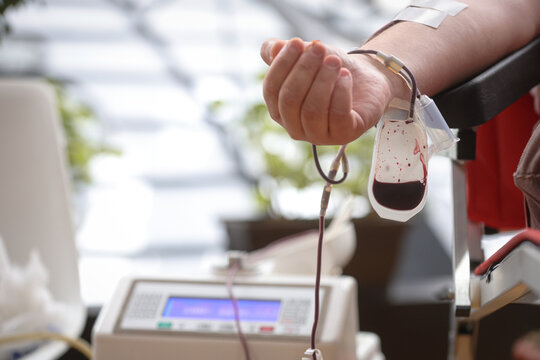 Blood donor hand detail during blood donation procedure