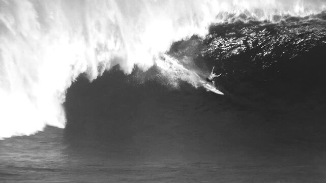 big surfer surfing the tsunami style waves maui hawaii