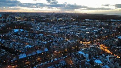 Obraz premium Drone Aerial View of Den Haag Neighborhood with Snowy Roofs at Sunset, Den Haag, The Hague, Netherlands