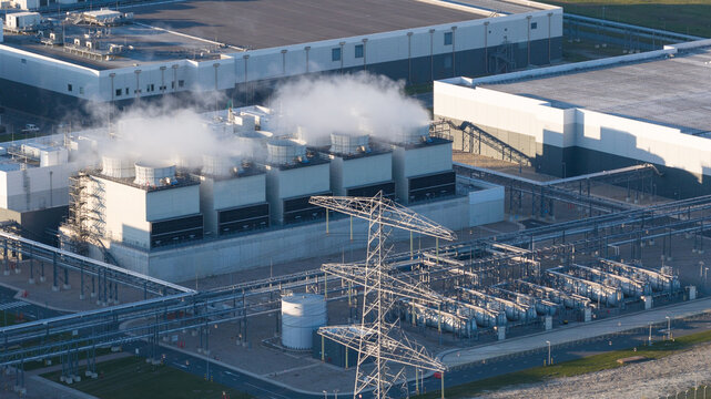 Aerial view of the Google Data Center with steam rising from cooling towers and industrial infrastructure, Eemshaven, Groningen, Netherlands.