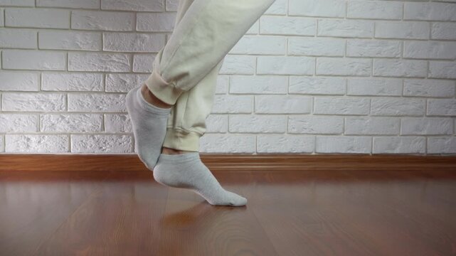 Woman doing a calf raise. Single-leg calf raise