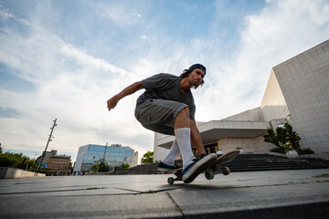 Skateboarder performing ollie trick in city square © Zoran Jesic