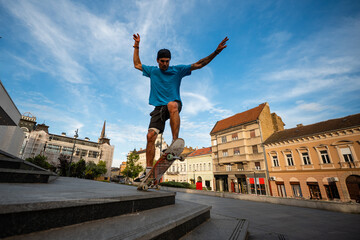 Skater performing trick in urban city square © Zoran Jesic