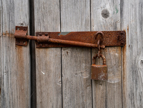 Old rusted lock on a barn door