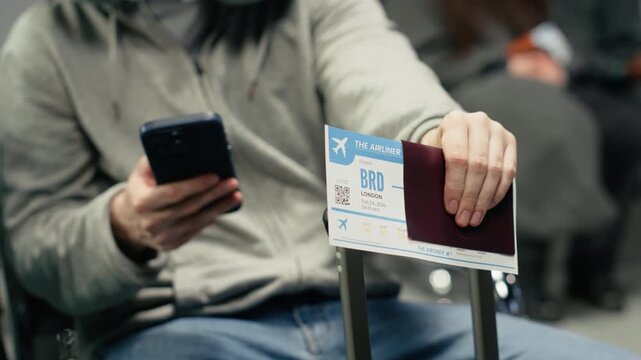 Waiting for plane arrival, boarding pass and man in airport checking flight itinerary on smartphone. Doing trip planning, passport document and passenger using phone, camera A