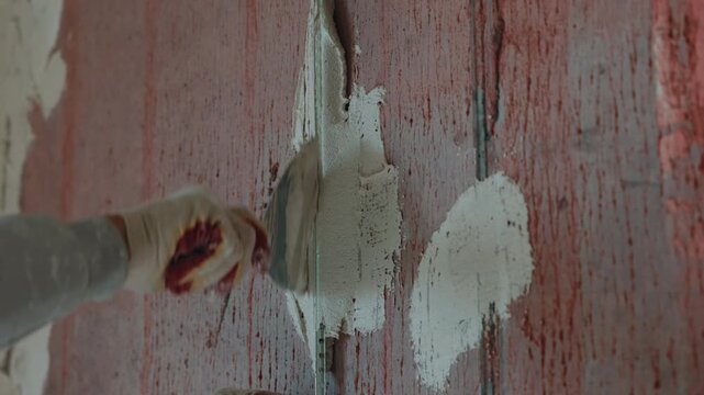 Installing plaster beacons on wall for surface leveling close up