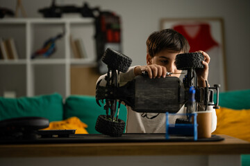 Boy repairing rc monster truck at home © Zoran Jesic