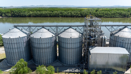 Large industrial grain silos and conveyor system for agricultural storage © Amatis Art