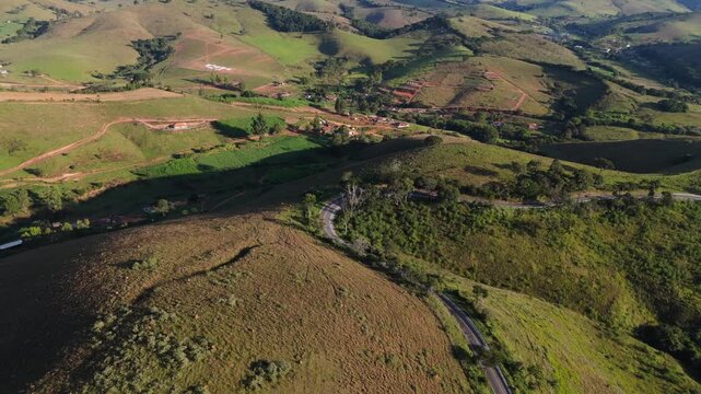 Drone capturando o movimento de autom&oacute;veis  estrada sinuosa entre morros da Serra da Mantiqueira.	
