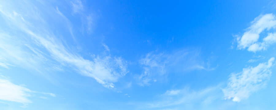 Panoramic vibrant blue sky background with soft white clouds and bright daylight for natural backdrop and clean outdoor design
