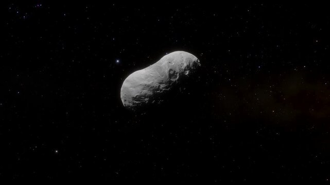 Animation of rotating asteroid 2598 Merlin drifting through deep space with stars in background. 