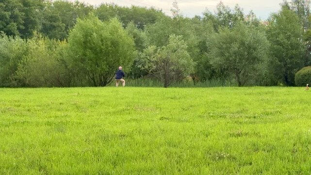 Man meditating karate practice on grass solitary practitioner rehearses hand-to-hand combat techniques and controlled stances
