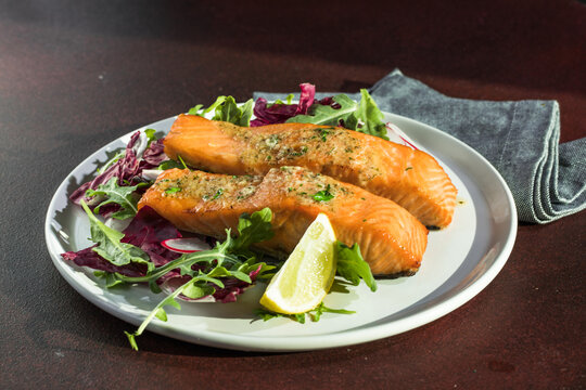 Salmon. Fried salmon steak with red radicchio cabbage, radish and arugula.