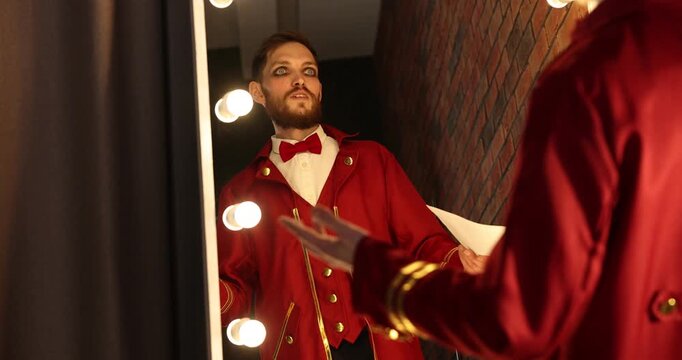 Actor with script rehearsing his lines near mirror in dressing room