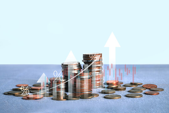 Stacks of coins with rising arrow graph and percentage icons. Investment growth, stock market analysis, increasing interest rates, and financial success.