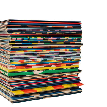A tall stack of colorful vintage magazines and comic books isolated on a white background.