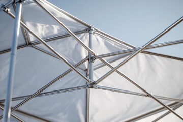 Fototapeta premium Close up of a collapsible canopy frame against a blue sky