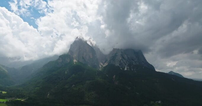Aerial of Schlern mountain shrouded by clouds, Dolomites, Italy
