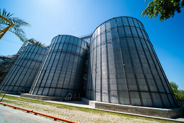 Massive industrial grain silos at a modern agricultural storage facility © Amatis Art