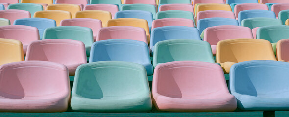 Obraz premium Empty colorful stadium seats in a retro pastel palette