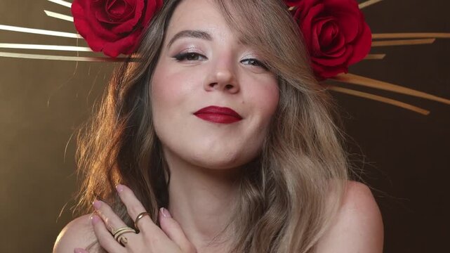 60 fps video. Female fashion portrait of young adult white beauty woman with bare shoulder, red lips, DIY golden halo crown and rose on head, make up, gold ring. Magic holy fantasy lady on smoke, fog