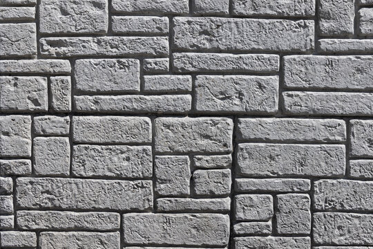 Gray stone wall pattern forming a textured surface
