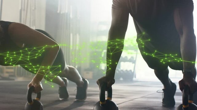 Two athletes gripping KBs, lowering, pressing up, green network tracking forearms, guiding training
