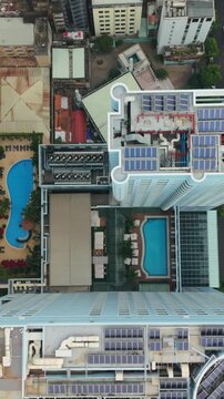 Vertical screen, Vietnam, Ho Chi Minh Aerial Dense Neighborhood Rooftops With Pools And Solar Panels, Tight Laneways, Mixed Lowrise Buildings, Varied Roof Textures, Residential Energy