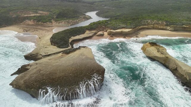 Sherbrook River Beach, Great Ocean Road, Port Campbell, Victoria: 4K aerial drone footage of river mouth, sandy beach, coastline and coastal cliffs near Thunder Cave and Mutton Bird Island