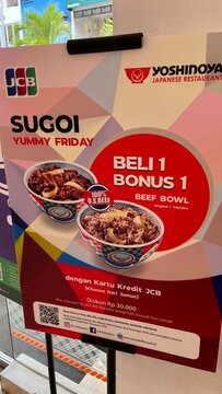 Yoshinoya Japanese Restaurant promotional poster for JCB credit card users featuring Sugoi Yummy Friday buy one get one free beef bowl offer - Bali, Indonesia, March 29, 2023