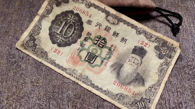 Close up video showing the engraved portrait on an antique Bank of Chosen 10 yen banknote issued in Korea under Japanese rule, likely from 1932.