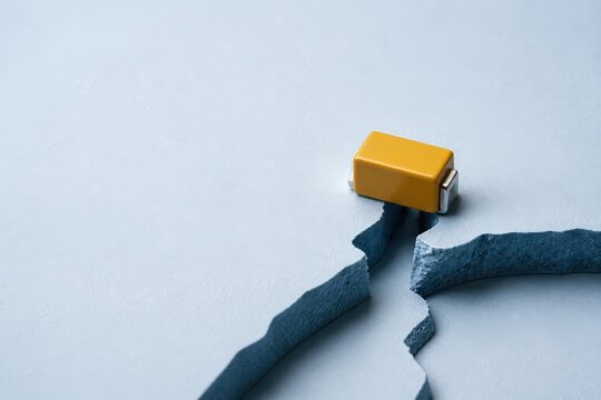 Yellow eraser tearing blue paper on light background