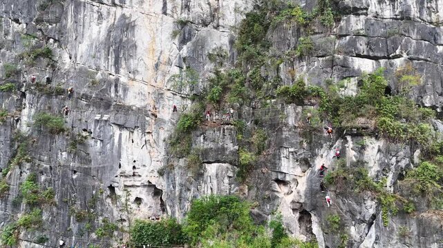 Hardcore Rock Climbing on Steep Karst Wall, Team Using Rope Systems and Protection