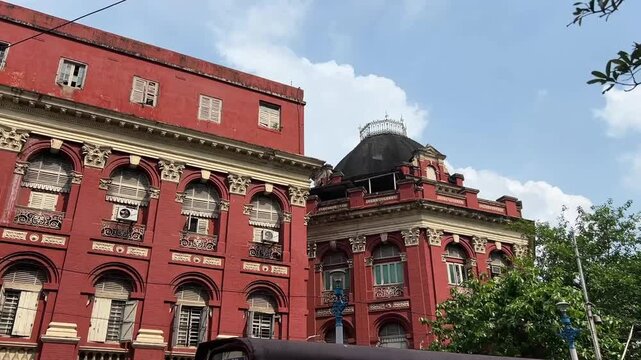 The iconic red facade of the Writers' Building (Mahakaran), a magnificent example of Victorian Greco-Roman architecture and the historic secretariat of West Bengal, India.