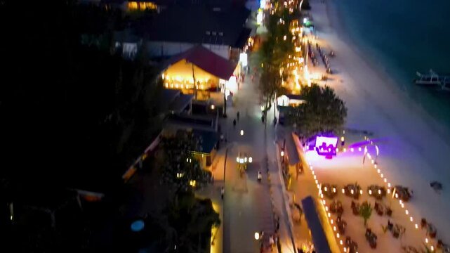 Night aerial panorama of Gili Trawangan with coastal roads and illuminated island