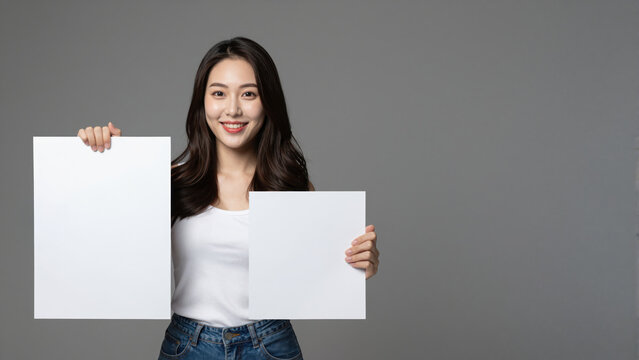 Blank Canvas in Hand: A confident individual holds up two blank canvases, her inviting smile promises endless creative possibilities, ready for a world of ideas. 