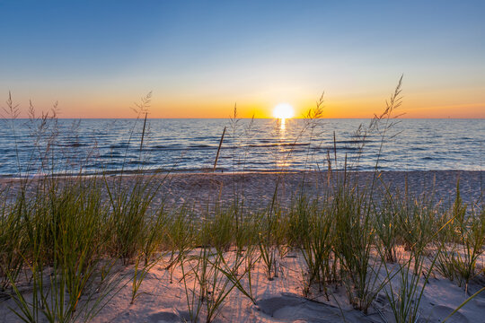 Lake Michigan sunset over sandy beach dunes