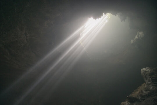 Sun ray falling into Jomblang Cave, Central Java, Indonesia
