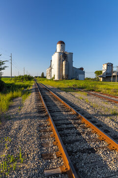 Grain elevator standing by railroad tracks in rural Midwest