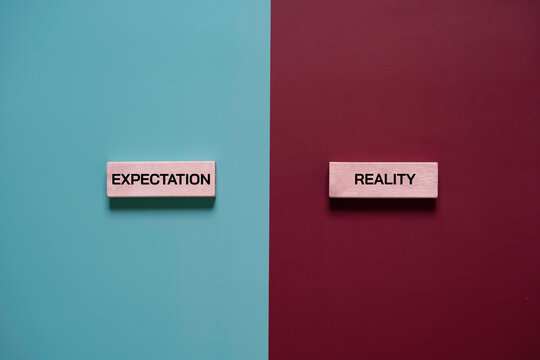 Expectation versus reality concept with wooden text blocks on contrasting backgrounds, symbolizing perception gap, business challenges, social media illusion and real life comparison