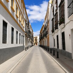 Fototapeta premium Charming Spanish Old Town Street Under Blue Sky
