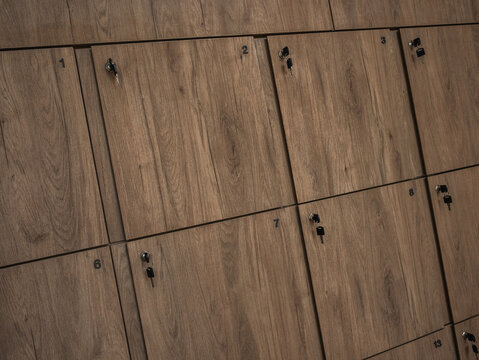 Wooden locker storage cabinets with keys in modern fitness and wellness studio