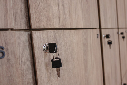 Wooden locker storage cabinets with keys in modern fitness and wellness studio