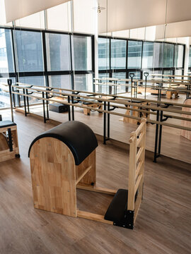 Pilates Ladder Barrel equipment in modern wellness studio with mirrored fitness interior