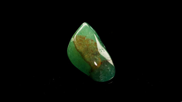 Polished Green Aventurine Gemstone with Natural Patterns on Black Background