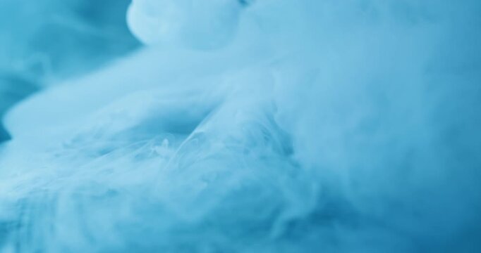 Liquid splash. Blue haze vapor. Defocused color cold creative texture mist steam explode glass water acrylic smog fluid on abstract art background.