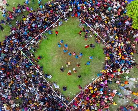 Nilphamari, Bangladesh - 01 May 2026: Aerial view of a large crowd of people gathered around a square grass field for a traditional sporting event or local festival.